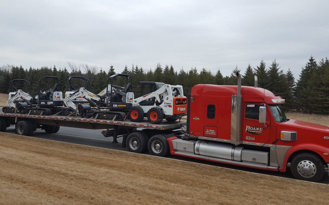Roane Transportation truck on the road with a load of Bobcat equipment