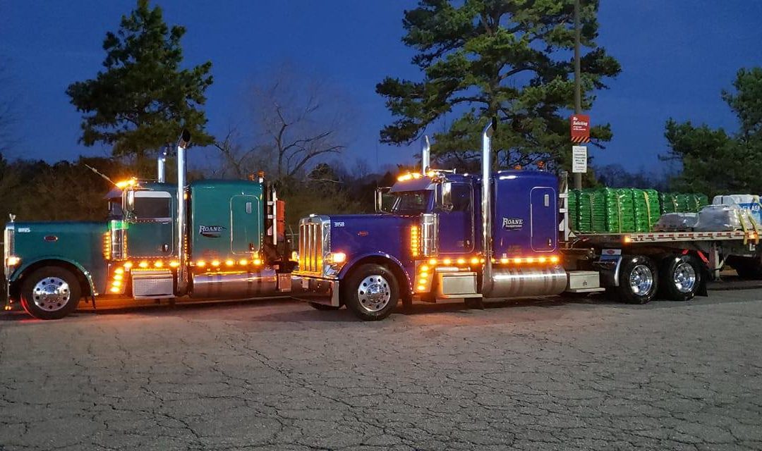 Couple of roane transportation trucks at a truck stop