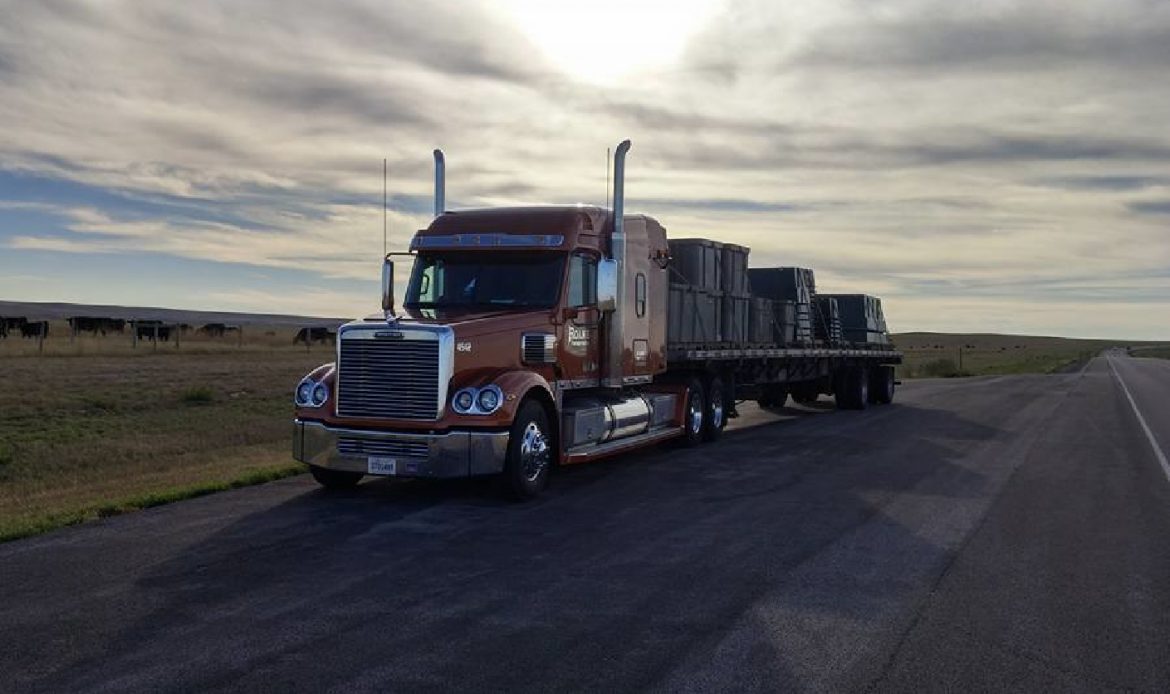 Roane Transportation truck and trailer on the side of the road while driver takes a drive time rest.
