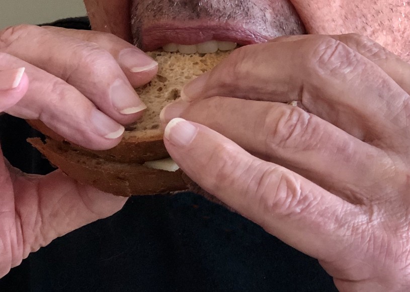 up close of a man taking a bite out of a sandwich