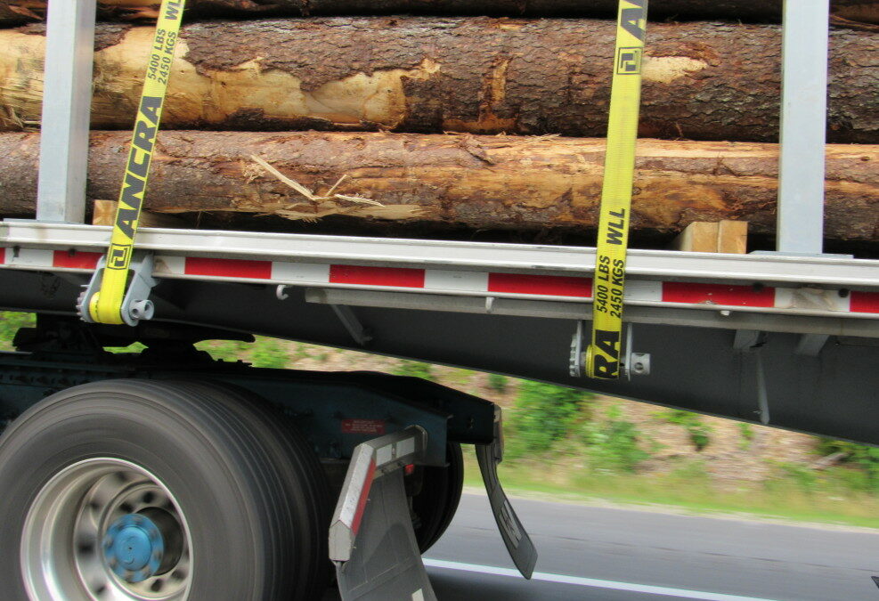 flatbed trailer truck pulling logs