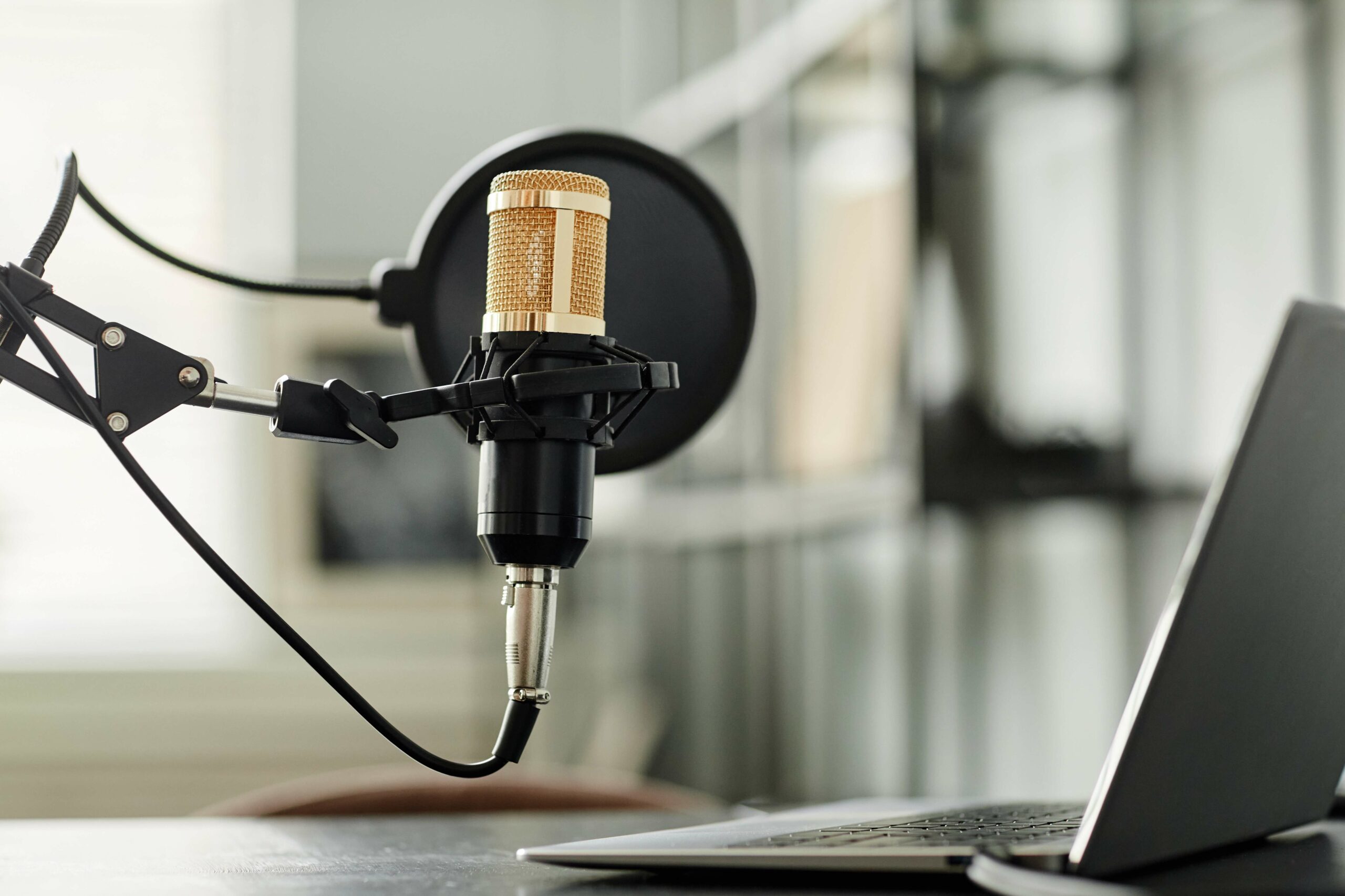 podcast microphone sitting near a computer